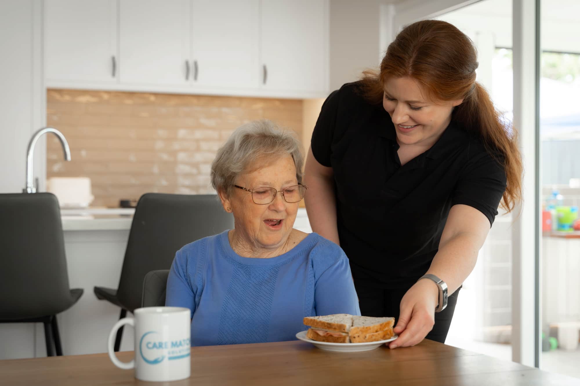 Nurse helping elderly woman after Australian aged care reforms