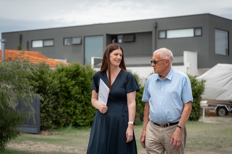 age care consultant helping older man around facility