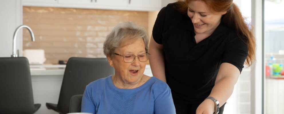 Nurse helping elderly woman after Australian aged care reforms