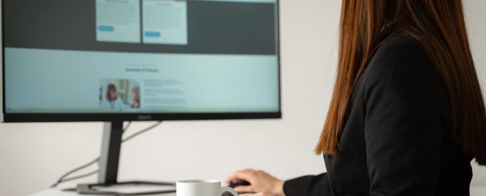 Woman on computer looking government aged care funding
